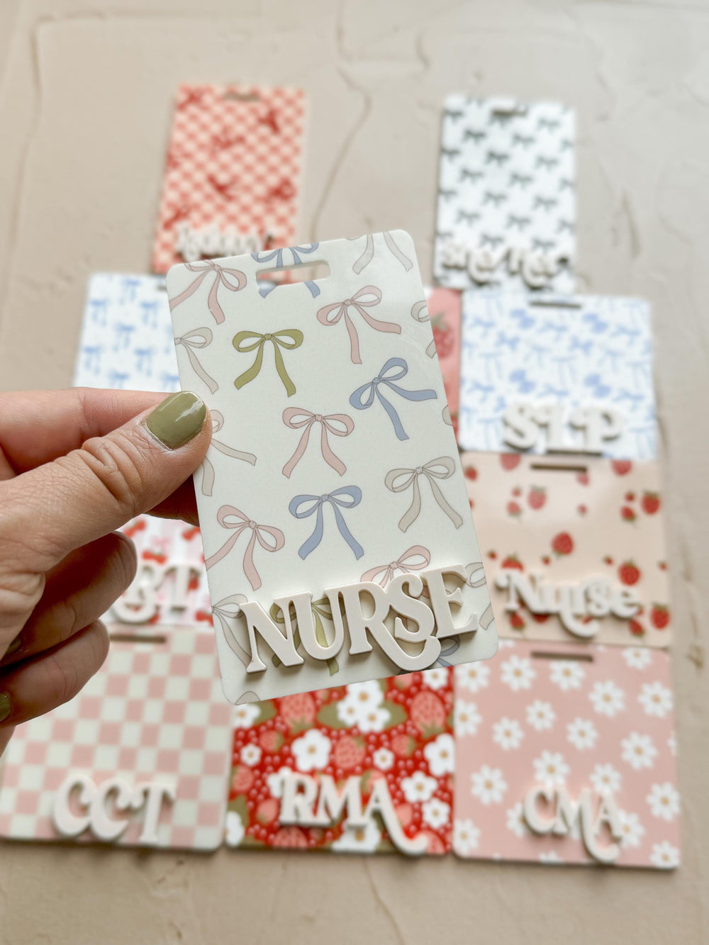 A set of six white wooden name tags with different patterns and the words "", "CMA", "RMA", "OCT", "STP", and "".