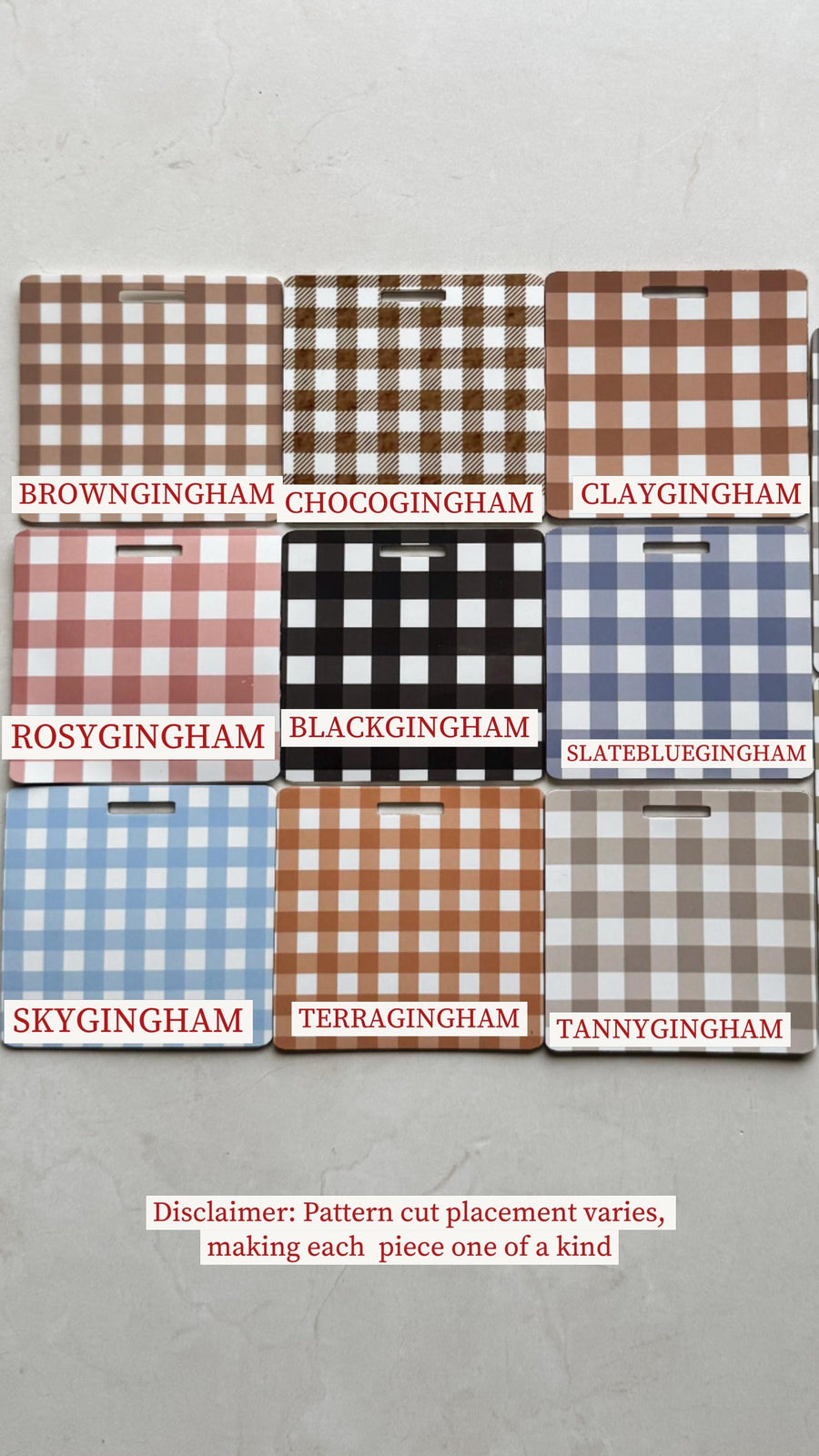 Nine rectangular cutting boards with gingham patterns in various colors, including brown, black, and blue. Each board has a small handle cutout. Text on the boards reads "BROWNGINGHAM", "CHOCOGINGHAM"
