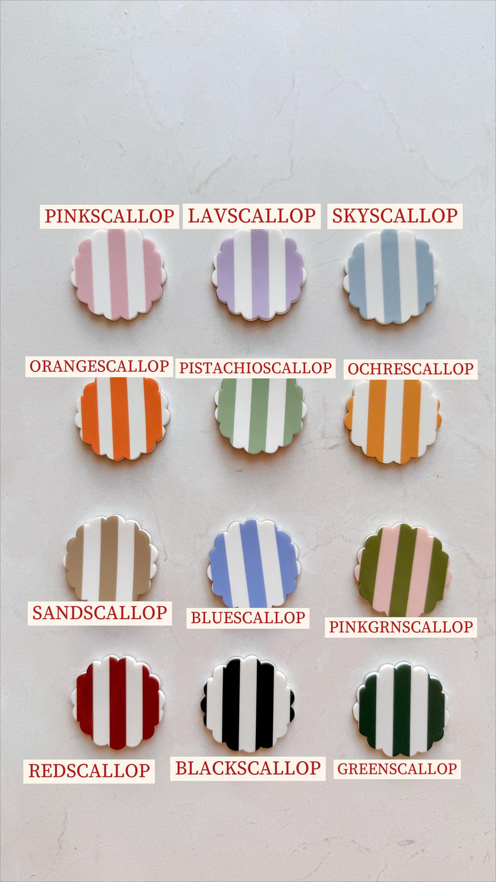A collection of twelve scalloped-edge decorative items with vertical stripes in various colors, including pink, lavender, blue, orange, green, brown, and black. Each item has a unique color combinatio