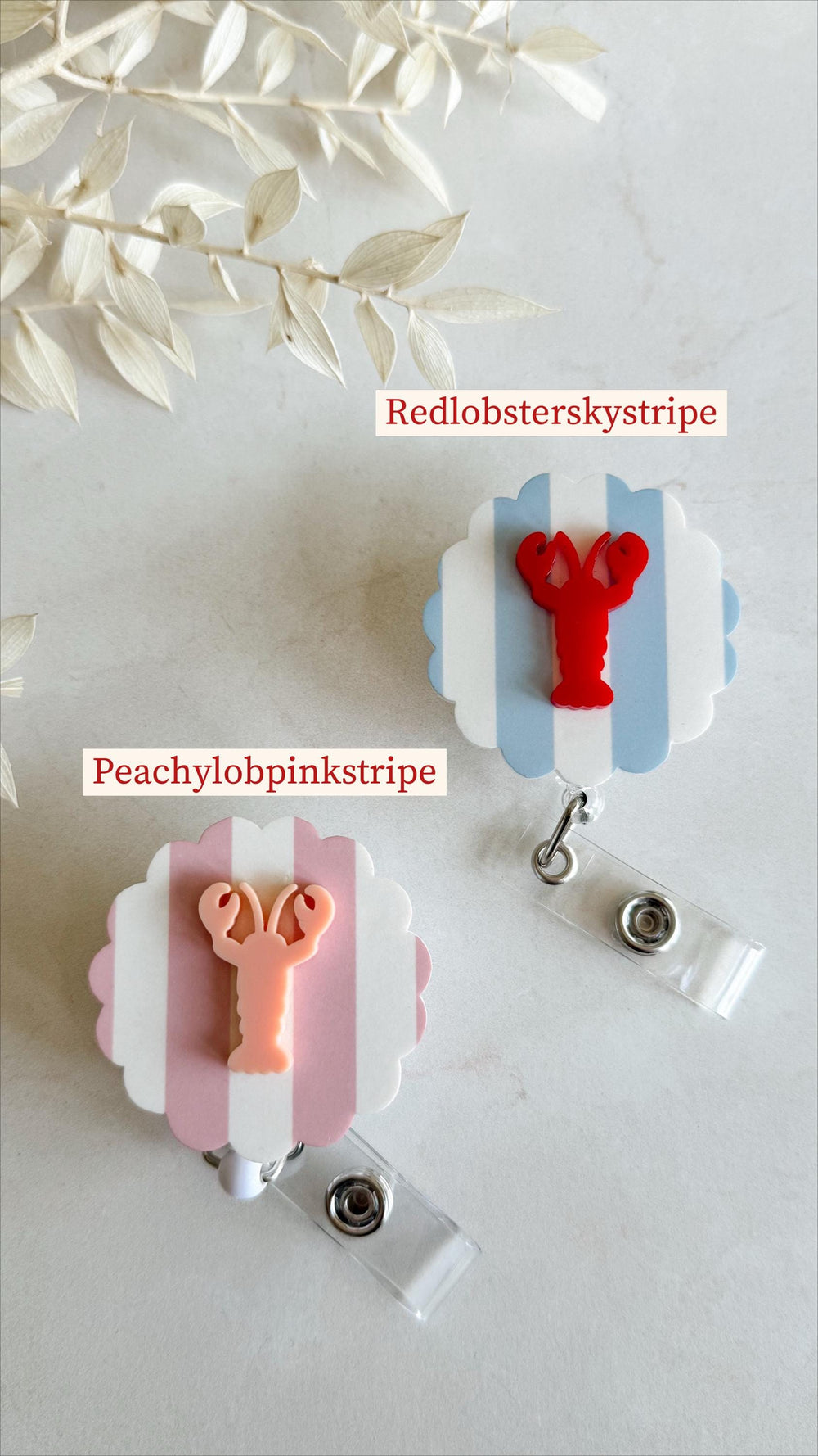 Two badge reels with lobster designs. One has a red lobster on a blue and white striped background, labeled "Redlobsterskystripe." The other features a pink lobster on a pink and white striped backgro