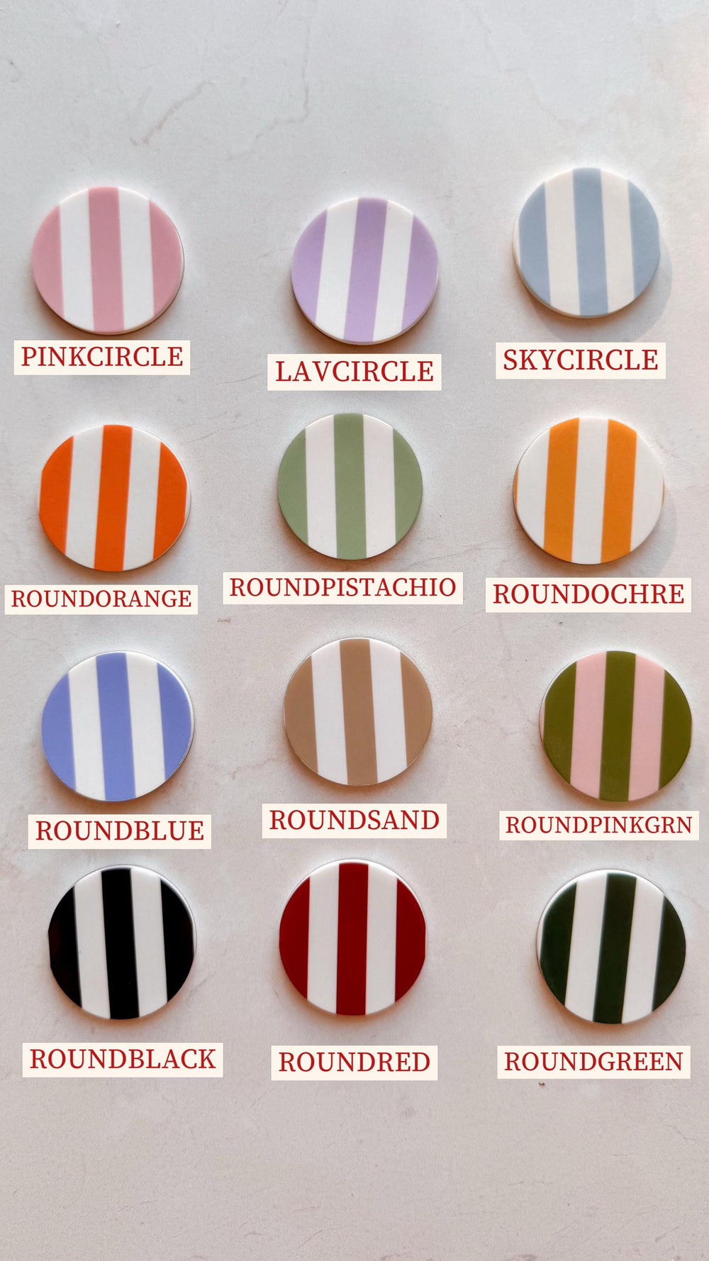 A collection of twelve round, striped decorative items in various colors, including pink, lavender, blue, orange, green, and black. Each item has a white background with vertical stripes and a corresp