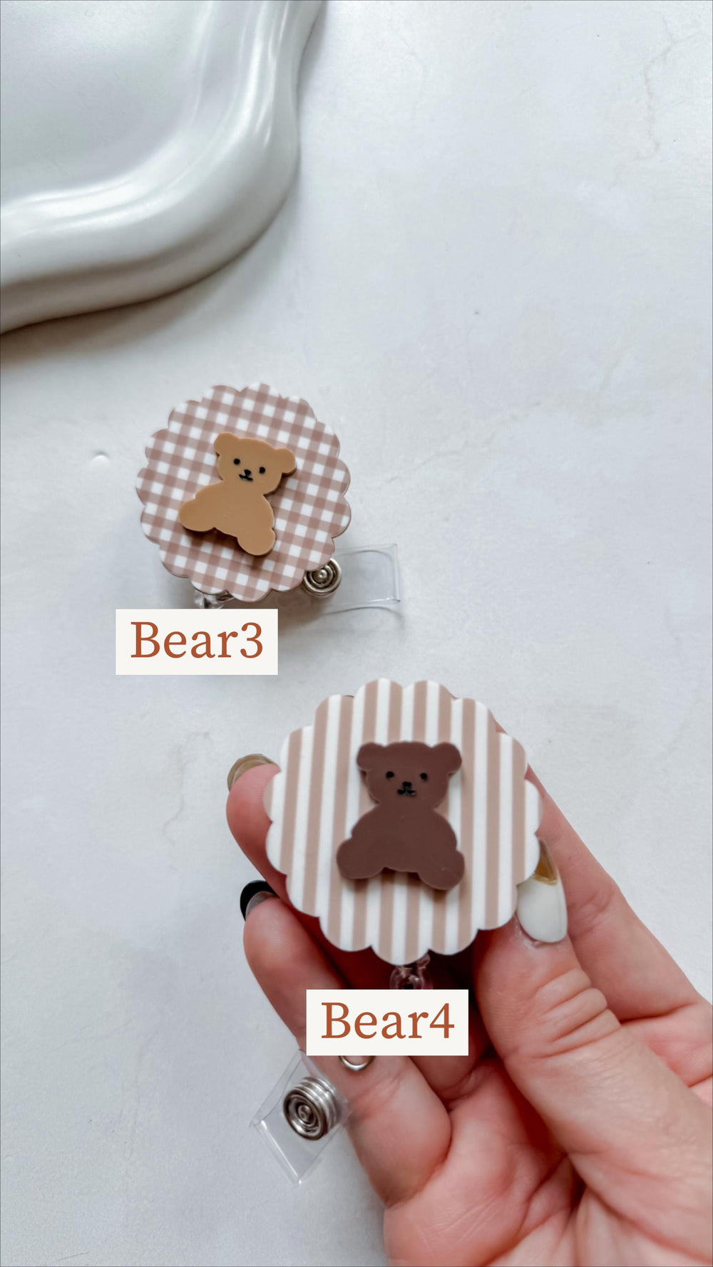 Two badge reels with bear designs. One has a brown and white gingham pattern, the other has a striped pattern. Both have a brown bear applique. The text "Bear3" and "Bear4" are printed on the badges.