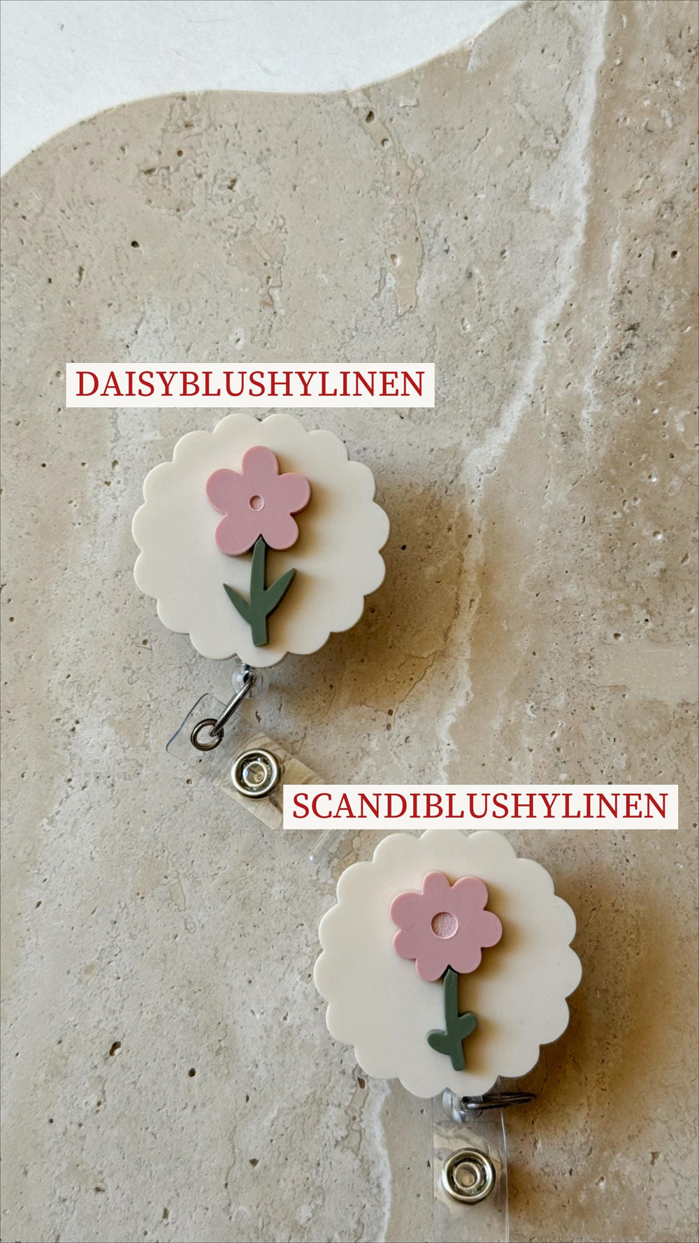 Two white badge reels with a scalloped edge, each featuring a pink flower with a green stem. The text "DAISYBLUSHYLINEN" and "SCANDIBLUSHYLINEN" are printed on the image. The reels have a clear plasti
