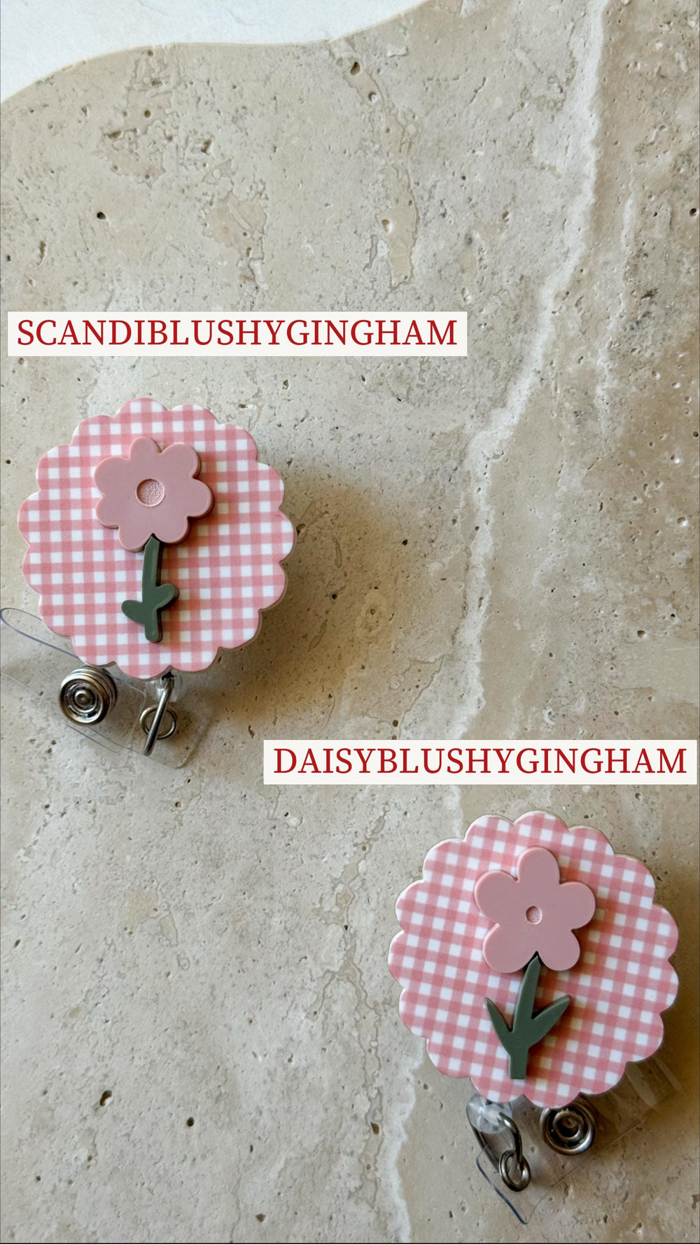 Two floral badge reels with a pink and white gingham pattern. Each reel features a pink flower with a green stem. The text "SCANDIBLUSHYGINGHAM" and "DAISYBLUSHYGINGHAM" are printed on the image.