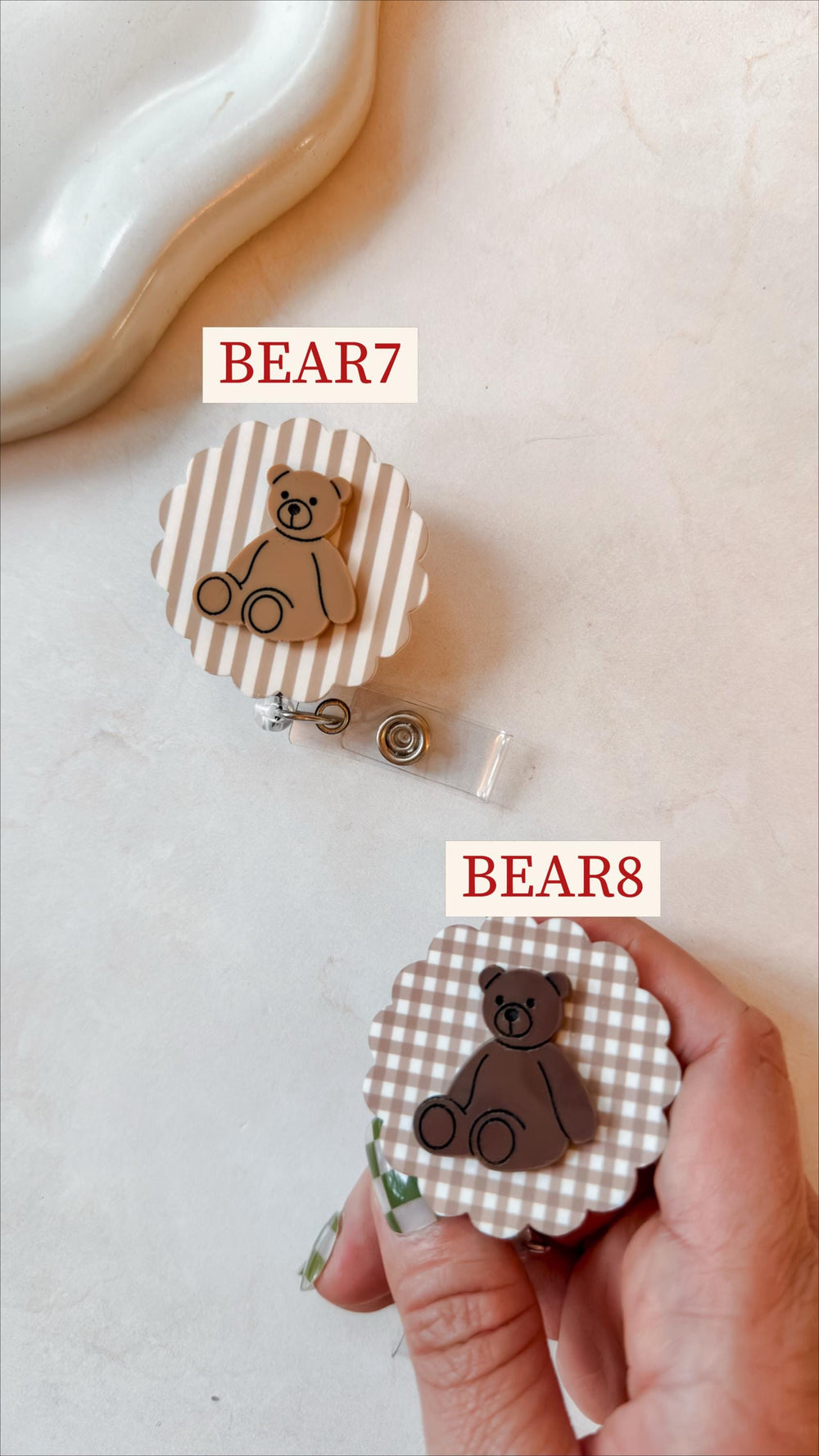 Two badge reels with teddy bear designs. One reel has a tan and white striped background, the other has a brown and white checkered background. The text "BEAR7" and "BEAR8" are printed on the image.